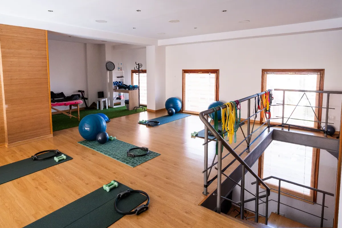 Therapeutic exercise and pilates room with mats, exercise balls and resistance bands