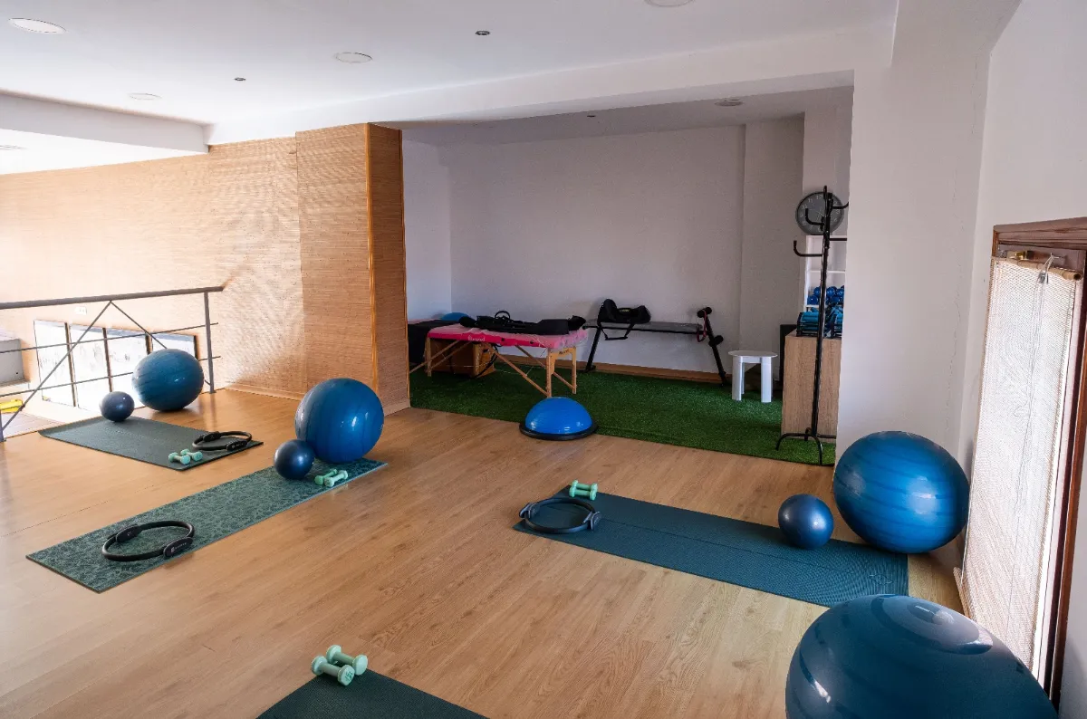 Exercise area with mats, exercise balls and a treatment table on artificial turf